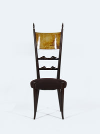 A chair with a high backrest by designer Aldo Tura chair