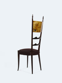 A chair with a high backrest by designer Aldo Tura