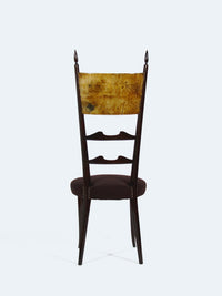 A chair with a high backrest by designer Aldo Tura